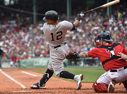 Jul 25, 2021; Boston, Massachusetts, USA;  New York Yankees second baseman Rougned Odor (12) hits an RBI single during the third inning against the Boston Red Sox at Fenway Park. Mandatory Credit: Bob DeChiara-USA TODAY Sports