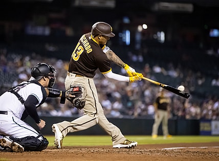 Aug 31, 2021; Phoenix, Arizona, USA; San Diego Padres third baseman Manny Machado hits a two run home run in the fifth inning against the Arizona Diamondbacks at Chase Field. Mandatory Credit: Mark J. Rebilas-USA TODAY Sports