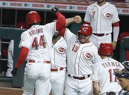 Sep 4, 2021; Cincinnati, Ohio, USA; Cincinnati Reds left fielder Aristides Aquino (44) reacts with first baseman Joey Votto (19) after hitting a three run home run against the Detroit Tigers during the third inning at Great American Ball Park. Mandatory Credit: David Kohl-USA TODAY Sports