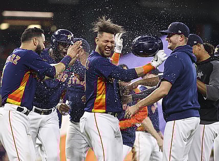 Oct 3, 2021; Houston, Texas, USA; Houston Astros first baseman Yuli Gurriel (10) celebrates with teammates after hitting a game-winning RBI single during the ninth inning against the Oakland Athletics at Minute Maid Park. Mandatory Credit: Troy Taormina-USA TODAY Sports