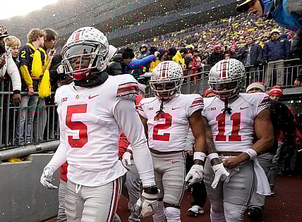 Ohio State Buckeyes wide receivers Garrett Wilson (5), Chris Olave (2) and Jaxon Smith-Njigba (11) take the the field for the NCAA football game against the Michigan Wolverines at Michigan Stadium in Ann Arbor on Sunday, Nov. 28, 2021.

Ohio State Buckeyes At Michigan Wolverines