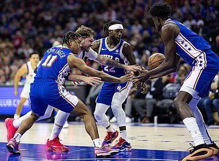 Feb 5, 2024; Philadelphia, Pennsylvania, USA; Dallas Mavericks guard Luka Doncic (77) and Philadelphia 76ers guard Jaden Springer (11) and guard Patrick Beverley (22) chase a loose ball during the second quarter at Wells Fargo Center. Mandatory Credit: Bill Streicher-USA TODAY Sports