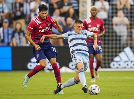Jul 31, 2021; Kansas City, Kansas, USA; Sporting Kansas City midfielder Remi Walter (54) passes the ball as FC Dallas forward Ricardo Pepi (16) defends during the first half at Children's Mercy Park. Mandatory Credit: Jay Biggerstaff-USA TODAY Sports