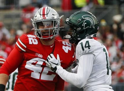 Michigan State Spartans cornerback Khary Crump (14) and Ohio State Buckeyes long snapper Bradley Robinson (42) share words after a punt return.

Syndication The Columbus Dispatch