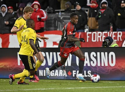 Mar 11, 2023; Toronto, Ontario, CAN; Toronto FC midfielder Richie Laryea (22) controls the ball against Columbus Crew defender Philip Quinton (2) and Columbus Crew midfielder Jimmy Medranda (94) in the second half in a MLS game at BMO Field. Mandatory Credit: Dan Hamilton-USA TODAY Sports