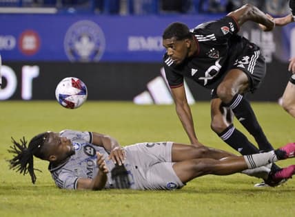 Apr 15, 2023; Montreal, Quebec, CAN; CF Montreal forward Chinonso Offor (9) and D.C. United defender Donovan Pines (23) collide after a head ball during the second half at Stade Saputo. Mandatory Credit: Eric Bolte-USA TODAY Sports