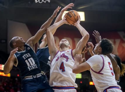 Bradley's Ahmet Jonovic (4) battles for a rebound with Utah State's Darius Brown II (10) in the second half of the Braves' home opener Saturday, Nov. 11, 2023 at Carver Arena.