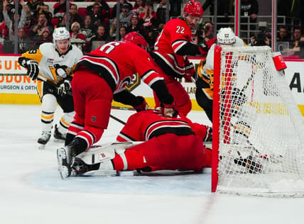 Jan 13, 2024; Raleigh, North Carolina, USA;  aCarolina Hurricanes goaltender Antti Raanta (32) stops the scoring chance by Pittsburgh Penguins right wing Rickard Rakell (67) during the second period t PNC Arena. Mandatory Credit: James Guillory-USA TODAY Sports