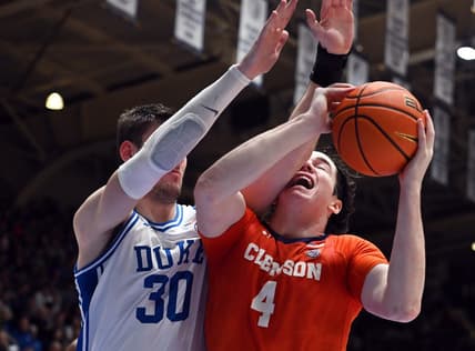 Jan 27, 2024; Durham, North Carolina, USA; Clemson Tigers forward Ian Schiefflelin (4) attempts to shot s Duke Blue Devils center Kyle Filipowski (30) defends during the first half at Cameron Indoor Stadium. Mandatory Credit: Rob Kinnan-USA TODAY Sports