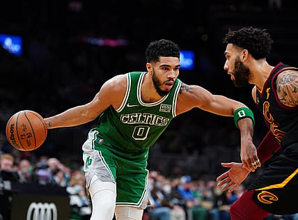 Dec 22, 2021; Boston, Massachusetts, USA; Boston Celtics forward Jayson Tatum (0) drives the ball against Cleveland Cavaliers guard Denzel Valentine (45) in the half quarter at TD Garden. Mandatory Credit: David Butler II-USA TODAY Sports
