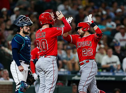 Aug 6, 2022; Seattle, Washington, USA;  Los Angeles Angels first baseman Jared Walsh (20) greets shortstop David Fletcher (22) after Fletcher hit a two-run home run against the Seattle Mariners during the sixth inning at T-Mobile Park. Mandatory Credit: Lindsey Wasson-USA TODAY Sports