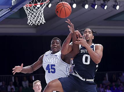 Nov 24, 2022; Paradise Island, BAHAMAS; Brigham Young Cougars forward Fousseyni Traore (45) and Butler Bulldogs forward D.J. Hughes (0) fight for a loose ball during the first half at Imperial Arena. Mandatory Credit: Kevin Jairaj-USA TODAY Sports