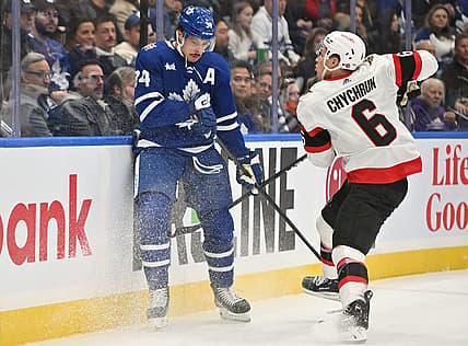 Nov 8, 2023; Toronto, Ontario, CAN; Ottawa Senators defenseman Jakob Chychrun (6) bodychecks Toronto Maple Leafs forward Auston Matthews (34) in the first period at Scotiabank Arena. Mandatory Credit: Dan Hamilton-USA TODAY Sports