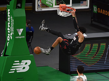 Apr 2, 2021; Boston, Massachusetts, USA;  Houston Rockets center Christian Wood (35) hangs onto the rim after dunking the ball during the second half against the Boston Celtics at TD Garden. Mandatory Credit: Bob DeChiara-USA TODAY Sports