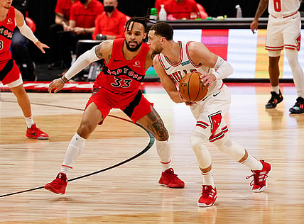 Apr 8, 2021; Tampa, Florida, USA; Chicago Bulls guard Zach LaVine (8) controls the ball against Toronto Raptors guard Gary Trent Jr. (33) during the second quarter at Amalie Arena. Mandatory Credit: Nathan Ray Seebeck-USA TODAY Sports