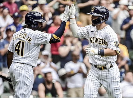 Jun 27, 2021; Milwaukee, Wisconsin, USA; Milwaukee Brewers first baseman Keston Hiura (18) is greeted by center fielder Jackie Bradley Jr. (41) after hitting a solo home run in the third inning against the Colorado Rockies at American Family Field. Mandatory Credit: Benny Sieu-USA TODAY Sports