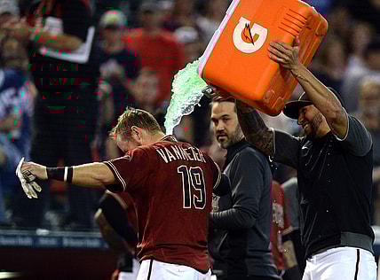 Oct 3, 2021; Phoenix, Arizona, USA; Arizona Diamondbacks left fielder David Peralta douses Arizona Diamondbacks second baseman Josh VanMeter (19) after a walk-off home run against the Colorado Rockies during the ninth inning at Chase Field. Mandatory Credit: Joe Camporeale-USA TODAY Sports