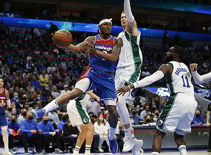 Nov 27, 2021; Dallas, Texas, USA; Washington Wizards guard Bradley Beal (3) passes the ball against Dallas Mavericks center Kristaps Porzingis (6) in the fourth quarter at American Airlines Center. Mandatory Credit: Tim Heitman-USA TODAY Sports