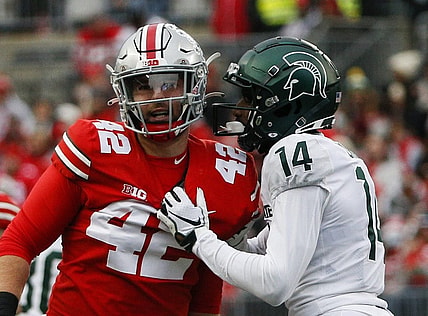 Michigan State Spartans cornerback Khary Crump (14) and Ohio State Buckeyes long snapper Bradley Robinson (42) share words after a punt return.

Syndication The Columbus Dispatch