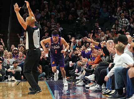 Dec 29, 2023; Phoenix, Arizona, USA; Phoenix Suns guard Devin Booker (1) celebrates a three point basket against the Charlotte Hornets during the first half at Footprint Center. Mandatory Credit: Joe Camporeale-USA TODAY Sports