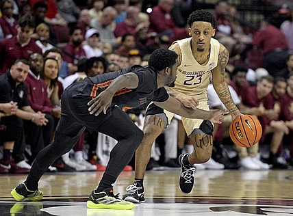 Mar 9, 2024; Tallahassee, Florida, USA; Florida State Seminoles guard Primo Spears (23) controls the ball against Miami Hurricanes guard Bensley Joseph (4) during the first half at Donald L. Tucker Center. Mandatory Credit: Melina Myers-USA TODAY Sports