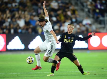 Sep 12, 2021; Los Angeles, California, USA; Real Salt Lake midfielder Nick Besler (13) moves the ball against Los Angeles FC midfielder Bryce Duke (19) during the first half at Banc of California Stadium. Mandatory Credit: Gary A. Vasquez-USA TODAY Sports