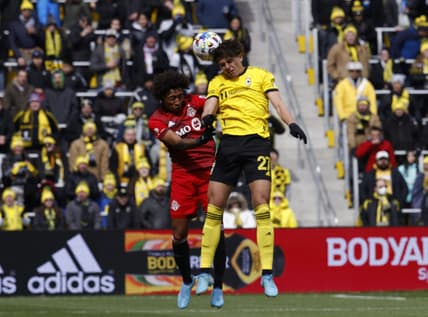 Mar 12, 2022; Columbus, Ohio, USA; Columbus Crew forward Miguel Berry (27) heads the ball against Toronto FC midfielder Jahkeele Marshall-Rutty (7) during the first half at Lower.com Field. Mandatory Credit: Greg Bartram-USA TODAY Sports