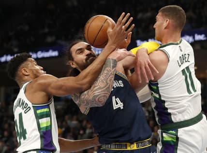 Mar 26, 2022; Memphis, Tennessee, USA;  Memphis Grizzlies center Steven Adams (4) and Milwaukee Bucks forward Giannis Antetokounmpo (34) and center Brook Lopez (11) fight for control of the ball during the first half at FedExForum. Mandatory Credit: Christine Tannous-USA TODAY Sports