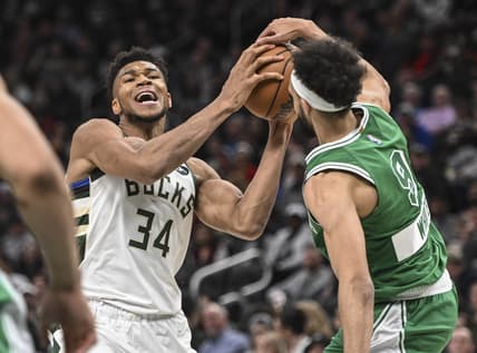Apr 7, 2022; Milwaukee, Wisconsin, USA; Milwaukee Bucks forward Giannis Antetokounmpo (34) gets pressure from Boston Celtics guard Derrick White (9) in the second quarter at Fiserv Forum. Mandatory Credit: Benny Sieu-USA TODAY Sports