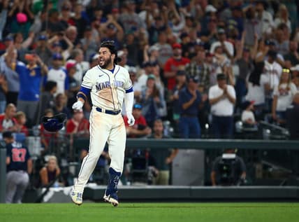 Sep 11, 2022; Seattle, Washington, USA;  Seattle Mariners third baseman Eugenio Suarez (28) throws his helmet as he celebrates his walk-off home run to beat the Atlanta Braves during the ninth inning at T-Mobile Park. The Mariners beat the Braves 8-7. Mandatory Credit: Lindsey Wasson-USA TODAY Sports