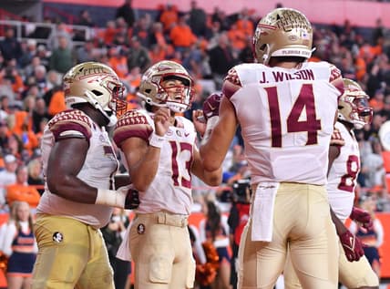Nov 12, 2022; Syracuse, New York, USA; Florida State Seminoles quarterback Jordan Travis (13) celebrates catching a touchdown pass with wide receiver Johnny Wilson (14) in the third quarter against the Syracuse Orange at JMA Wireless Dome. Mandatory Credit: Mark Konezny-USA TODAY Sports
