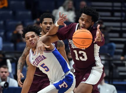 Mar 9, 2023; Nashville, TN, USA; Mississippi State Bulldogs forward Will McNair Jr. (13) and Florida Gators guard Will Richard (5) battle for a loose ball during the first half at Bridgestone Arena. Mandatory Credit: Christopher Hanewinckel-USA TODAY Sports