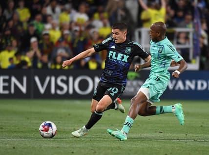 Apr 22, 2023; Nashville, Tennessee, USA; Los Angeles FC defender Sergi Palencia (30) handles the ball against Nashville SC midfielder Fafa Picault (7) during the first half at Geodis Park. Mandatory Credit: Christopher Hanewinckel-USA TODAY Sports