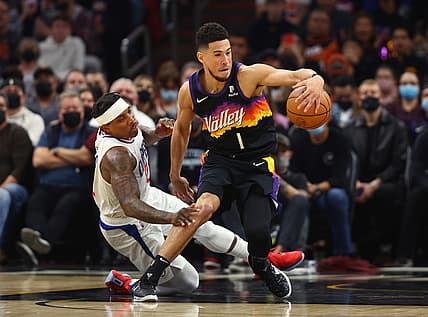 Jan 6, 2022; Phoenix, Arizona, USA; Phoenix Suns guard Devin Booker (1) moves the ball against Los Angeles Clippers guard Eric Bledsoe (12) in the first half at Footprint Center. Mandatory Credit: Mark J. Rebilas-USA TODAY Sports