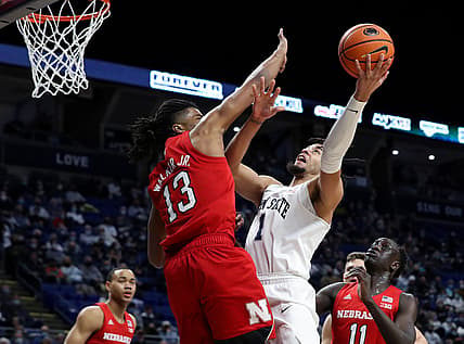Feb 27, 2022; University Park, Pennsylvania, USA; Penn State Nittany Lions forward Seth Lundy (1) drives the ball to the basket as Nebraska Cornhuskers forward Derrick Walker (13) defends during the first half at Bryce Jordan Center. Mandatory Credit: Matthew OHaren-USA TODAY Sports