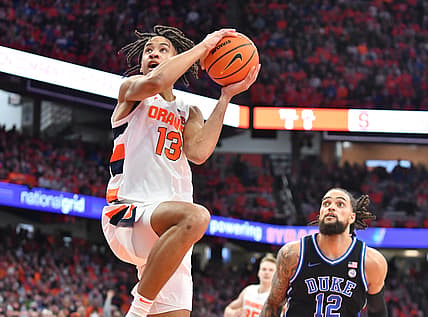Feb 26, 2022; Syracuse, New York, USA; Syracuse Orange forward Benny Williams (13) goes up for a shot as Duke Blue Devils forward Theo John (12) looks on in the second half at the Carrier Dome. Mandatory Credit: Mark Konezny-USA TODAY Sports