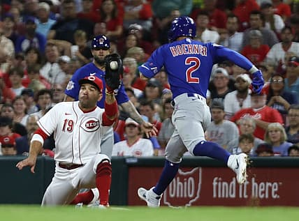 Aug 13, 2022; Cincinnati, Ohio, USA; Chicago Cubs shortstop Nico Hoerner (2) is out at first against Cincinnati Reds first baseman Joey Votto (19) during the sixth inning at Great American Ball Park. Mandatory Credit: David Kohl-USA TODAY Sports