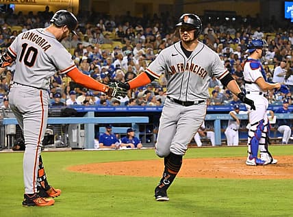 Sep 5, 2022; Los Angeles, California, USA;  San Francisco Giants third baseman J.D. Davis (7) is congratulated by third baseman Evan Longoria (10) after hitting a solo home run in the second inning against the Los Angeles Dodgers at Dodger Stadium. Mandatory Credit: Jayne Kamin-Oncea-USA TODAY Sports