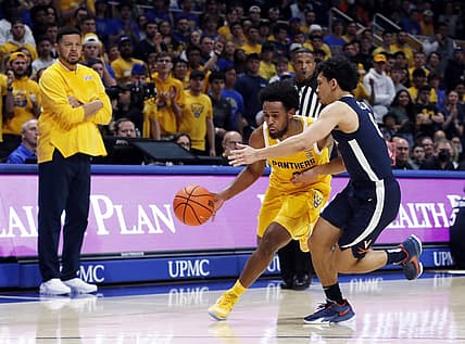 Jan 3, 2023; Pittsburgh, Pennsylvania, USA; Pittsburgh Panthers guard Nelly Cummings (0) drives to the basket against Virginia Cavaliers guard Kihei Clark (right) during the second half at the Petersen Events Center. Pittsburgh won 68-65. Mandatory Credit: Charles LeClaire-USA TODAY Sports