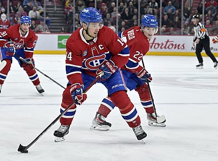 Nov 14, 2023; Montreal, Quebec, CAN; Montreal Canadiens forward Nick Suzuki (14) brings the puck in the Calgary Flames zone with the help of teammate forward Cole Caufield (22) during the third period at the Bell Centre. Mandatory Credit: Eric Bolte-USA TODAY Sports