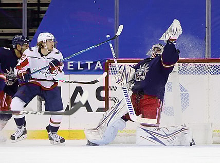 Feb 4, 2021; New York, NY, USA; Washington Capitals left wing Carl Hagelin (left) scores a goal against New York Rangers goaltender Igor Shesterkin (31) during the second period at Madison Square Garden. Mandatory Credit: Bruce Bennett/Pool Photo-USA TODAY Sports