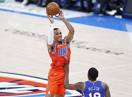 Apr 10, 2021; Oklahoma City, Oklahoma, USA; Oklahoma City Thunder forward Darius Bazley (7) passes the ball over Philadelphia 76ers guard Shake Milton (18) during the second quarter at Chesapeake Energy Arena. Mandatory Credit: Alonzo Adams-USA TODAY Sports
