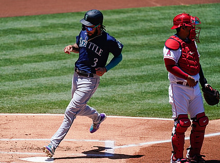 Jun 6, 2021; Anaheim, California, USA; Seattle Mariners shortstop J.P. Crawford (3) scores in the first inning on a sacrifice fly by Kyle Seager (not pictured) at Angel Stadium. Right is Los Angeles Angels catcher Kurt Suzuki (24). Mandatory Credit: Robert Hanashiro-USA TODAY Sports
