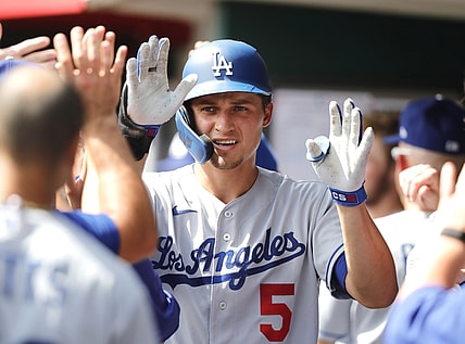 Sep 19, 2021; Cincinnati, Ohio, USA; Los Angeles Dodgers shortstop Corey Seager (5) celebrates in the dugout after hitting a two-run home run against the Cincinnati Reds during the third inning at Great American Ball Park. Mandatory Credit: David Kohl-USA TODAY Sports