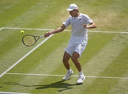 Jul 4, 2022; London, United Kingdom; Alex De Minaur (AUS) returns a shot during his match against Cristian Garin (CHI) on day eight at All England Lawn Tennis and Croquet Club. Mandatory Credit: Susan Mullane-USA TODAY Sports