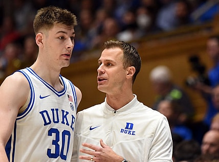 Dec 31, 2022; Durham, North Carolina, USA; Duke Blue Devils head coach Jon Scheyer (right) talks to center Kyle Filipowski (30) during the second half against the Florida State Seminoles at Cameron Indoor Stadium. The Blue Devils won 86-67.  Mandatory Credit: Rob Kinnan-USA TODAY Sports
