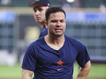 Jul 4, 2023; Houston, Texas, USA; Houston Astros designated hitter Jose Altuve (27) holds his side with an apparent injury while walking off the field during practice before the game against the Colorado Rockies at Minute Maid Park. Mandatory Credit: Troy Taormina-USA TODAY Sports