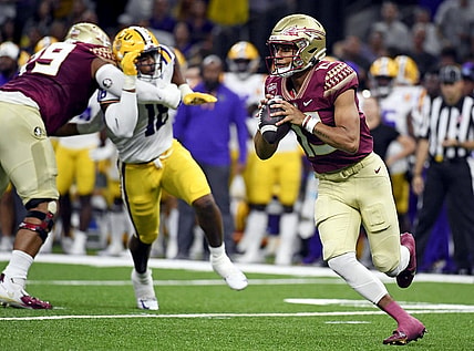 Sep 4, 2022; New Orleans, Louisiana, USA; Florida State Seminoles quarterback Jordan Travis (13) scrambles during the first half against the Louisiana State Tigers at Caesars Superdome. Mandatory Credit: Melina Myers-USA TODAY Sports