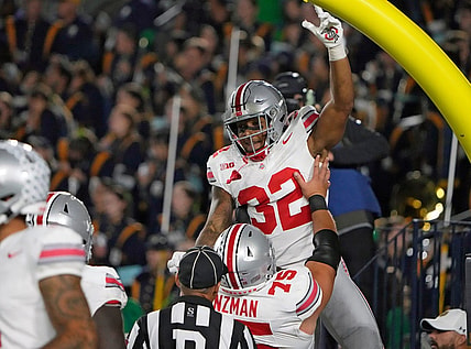 Sep 23, 2023; South Bend, Indiana, USA; Ohio State Buckeyes running back TreVeyon Henderson (32) celebrates his rushing touchdown with Ohio State Buckeyes offensive lineman Carson Hinzman (75) during the third quarter of their game against Notre Dame Fighting Irish at Notre Dame Stadium.