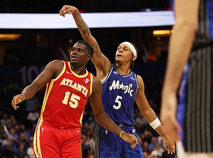 Jan 7, 2024; Orlando, Florida, USA; Orlando Magic forward Paolo Banchero (5) makes a three pointer over Atlanta Hawks center Clint Capela (15) during overtime at Kia Center. Mandatory Credit: Kim Klement Neitzel-USA TODAY Sports